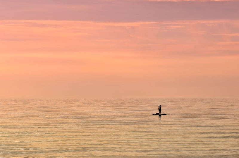 Paddleboarding in sunset